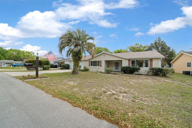 8450 SW 115th Street Rd, Ocala, FL 34481 - view of front of home with a front lawn, concrete driveway, central AC unit, and an attached garage