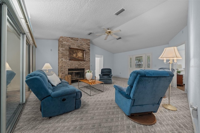 8450 SW 115th Street Rd, Ocala, FL 34481 - carpeted living area with vaulted ceiling, a fireplace, a textured ceiling, visible vents, and ceiling fan