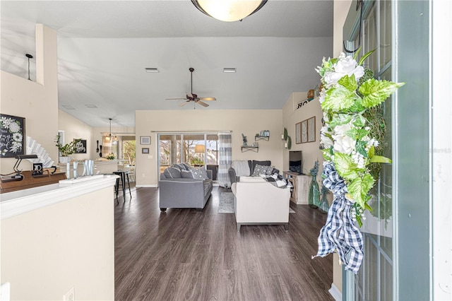 living room featuring vaulted ceiling, dark hardwood / wood-style floors, and ceiling fan