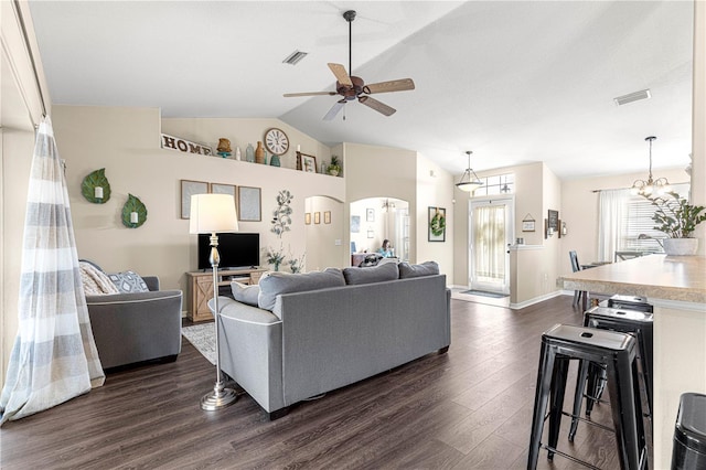 living room with vaulted ceiling, ceiling fan with notable chandelier, and dark hardwood / wood-style flooring