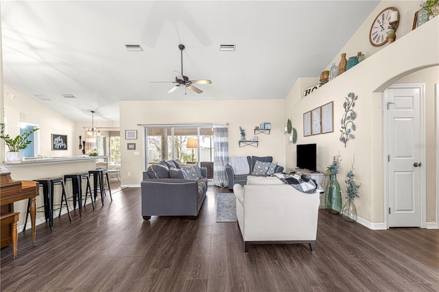 living room with dark wood-type flooring, vaulted ceiling, and ceiling fan