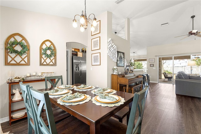 dining room featuring high vaulted ceiling, dark hardwood / wood-style flooring, and ceiling fan with notable chandelier