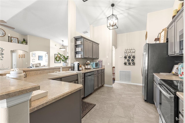 kitchen featuring gray cabinets, appliances with stainless steel finishes, ceiling fan with notable chandelier, sink, and hanging light fixtures