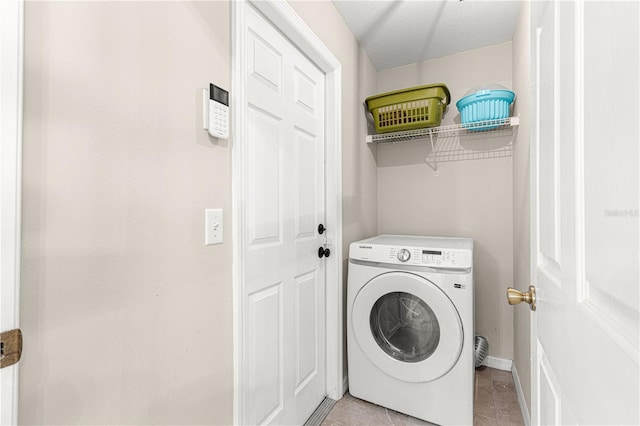 laundry room featuring light tile patterned floors and washer / dryer