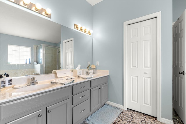 bathroom featuring vanity, tile patterned flooring, and a shower with door