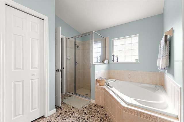 bathroom featuring tile patterned flooring and independent shower and bath