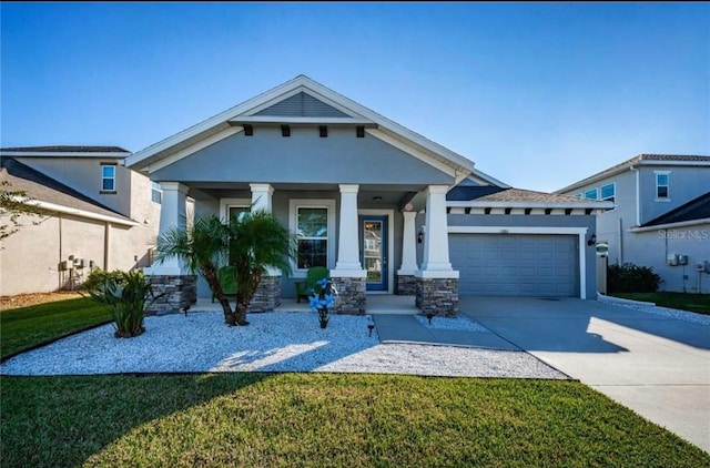 view of front of property featuring an attached garage, driveway, a front yard, and stucco siding