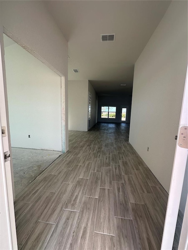 hallway with hardwood / wood-style flooring