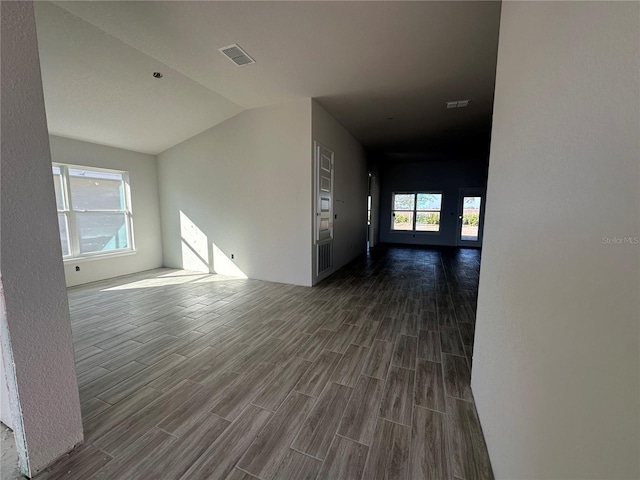 unfurnished room featuring vaulted ceiling