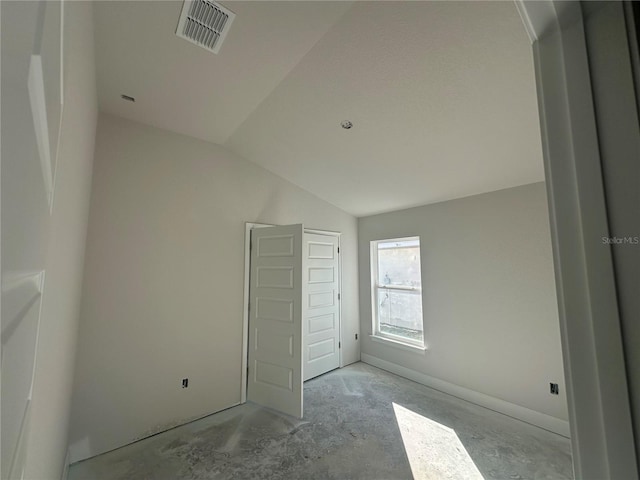 unfurnished bedroom with lofted ceiling