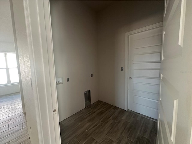 laundry room featuring dark hardwood / wood-style flooring and electric dryer hookup