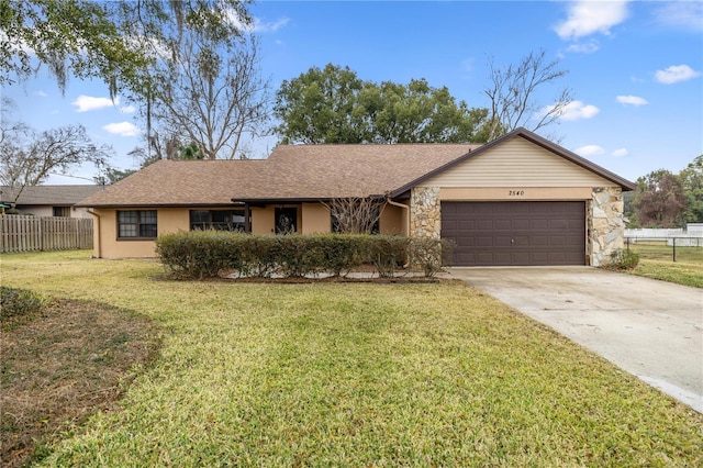 ranch-style home with a garage and a front yard