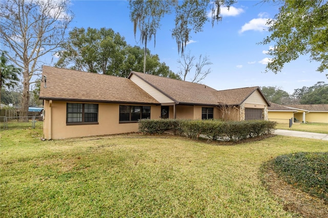 ranch-style house featuring a garage and a front yard