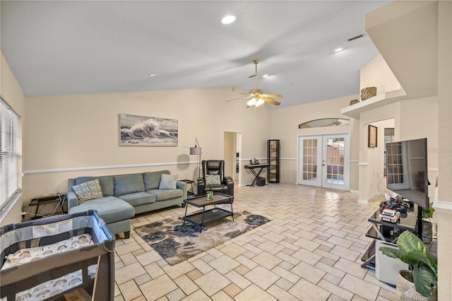 living room featuring vaulted ceiling, ceiling fan, and french doors