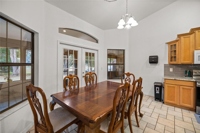 dining area with a chandelier and french doors