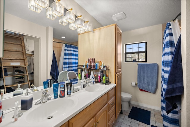 bathroom with tile patterned flooring, a chandelier, a shower with shower curtain, vanity, and toilet