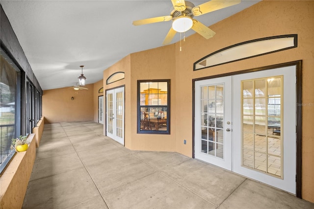 unfurnished sunroom featuring lofted ceiling, ceiling fan, and french doors