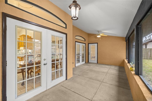 unfurnished sunroom featuring french doors, ceiling fan, and lofted ceiling