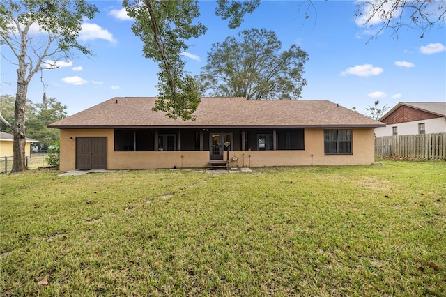 rear view of property with a lawn