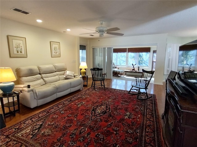living room with hardwood / wood-style flooring and ceiling fan