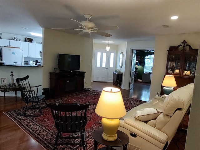 living room featuring hardwood / wood-style floors and ceiling fan