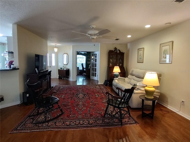 living room with ceiling fan and hardwood / wood-style floors