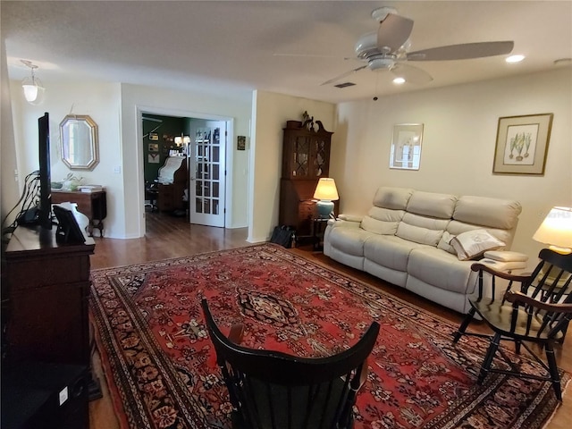 living room with ceiling fan and hardwood / wood-style floors