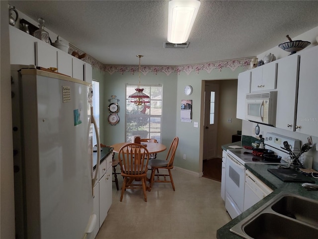 kitchen featuring sink, white cabinetry, decorative light fixtures, a textured ceiling, and white appliances
