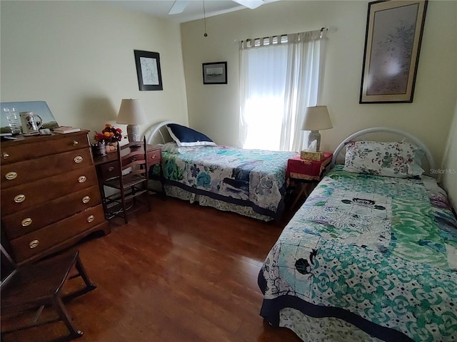 bedroom with dark wood-type flooring