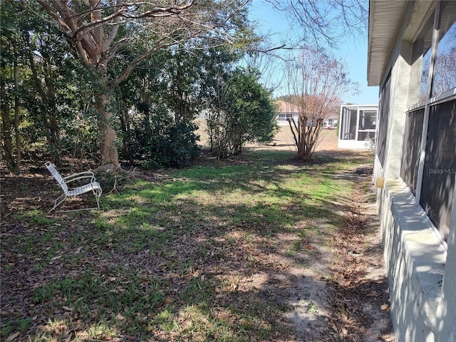 view of yard featuring a sunroom