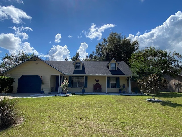 view of front of house with a front lawn, covered porch, and an attached garage