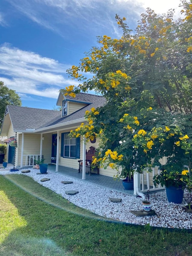 view of side of home with a yard