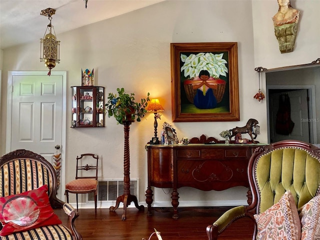 sitting room featuring baseboards, visible vents, and wood finished floors