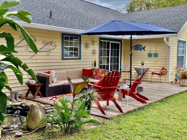 exterior space featuring a deck, a shingled roof, and outdoor lounge area