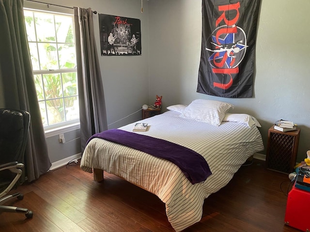 bedroom featuring baseboards and wood finished floors