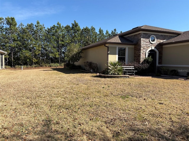 view of side of home featuring a lawn