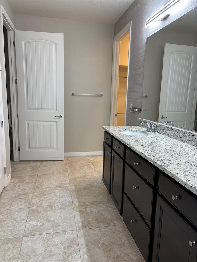 bathroom with vanity and tile patterned flooring