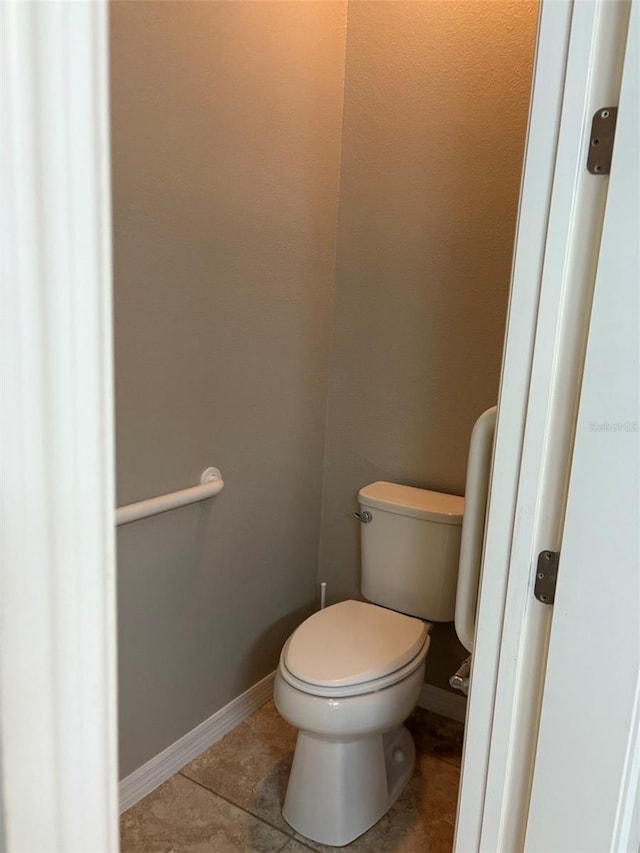 bathroom with tile patterned floors and toilet