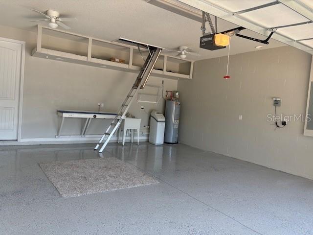 garage featuring a garage door opener and electric water heater