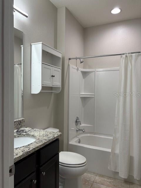 full bathroom featuring vanity, toilet, tile patterned flooring, and shower / tub combo