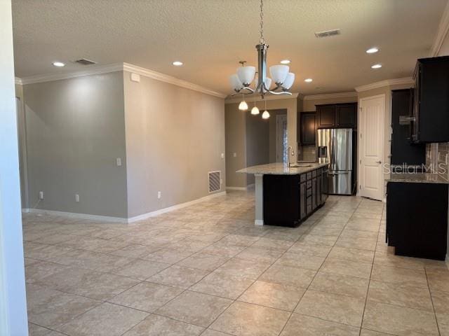 kitchen featuring stainless steel refrigerator with ice dispenser, sink, a chandelier, hanging light fixtures, and a textured ceiling