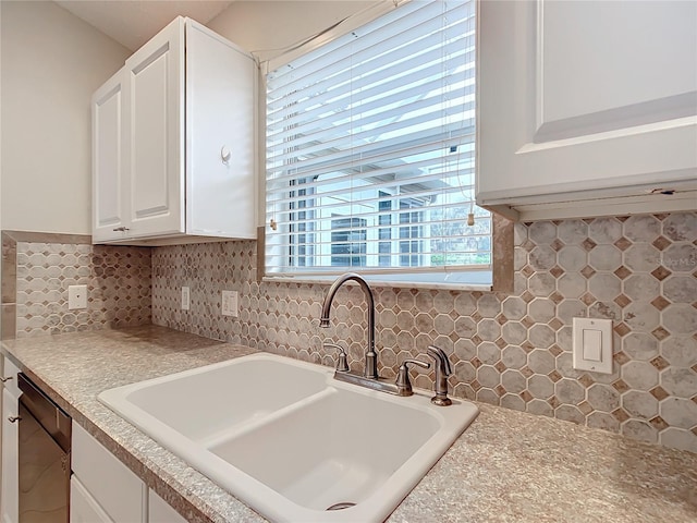 kitchen with sink, decorative backsplash, black dishwasher, and white cabinets