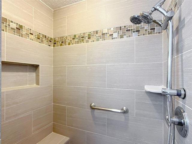 bathroom with tiled shower