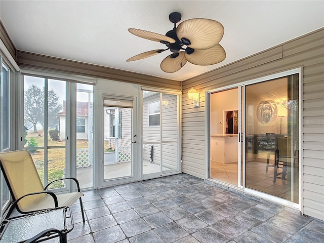 unfurnished sunroom with a healthy amount of sunlight and ceiling fan