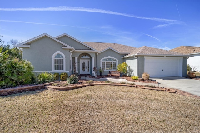 single story home featuring a garage and a front lawn