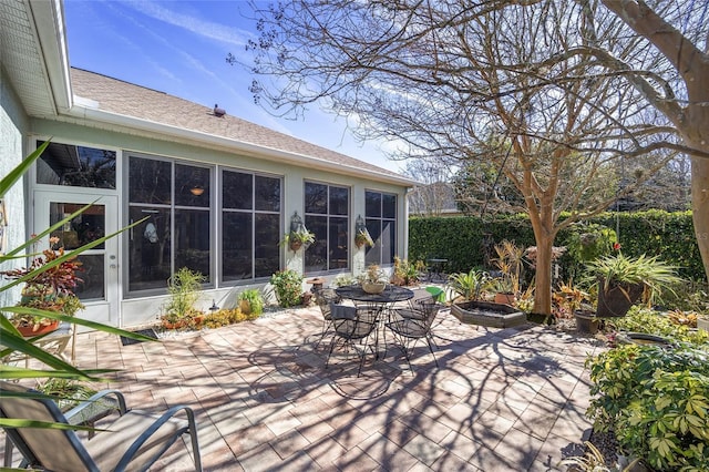 view of patio featuring a sunroom