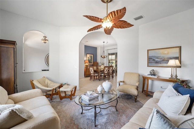 living room featuring light tile patterned flooring and ceiling fan