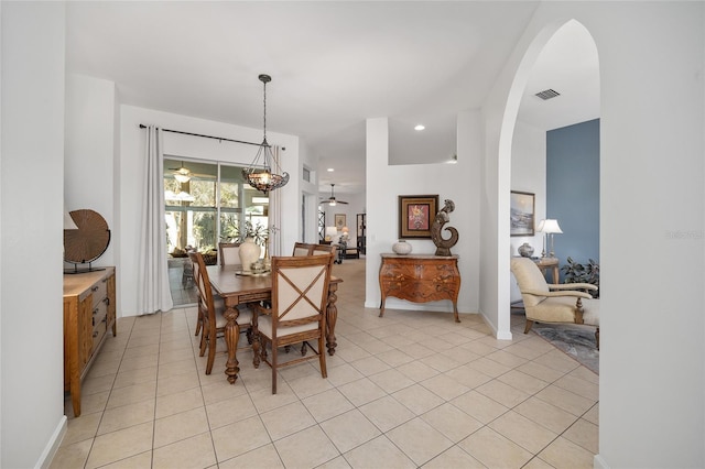 tiled dining space with ceiling fan