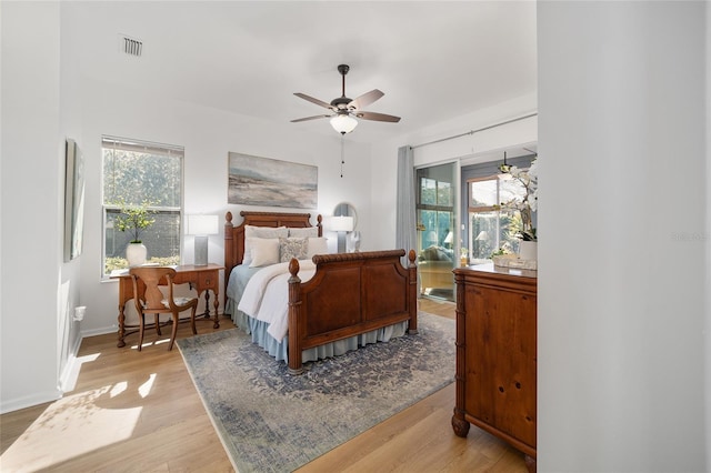 bedroom with ceiling fan and hardwood / wood-style floors