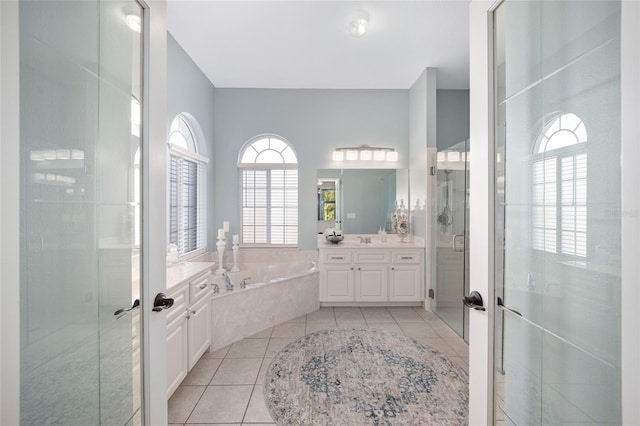 bathroom with independent shower and bath, a wealth of natural light, tile patterned floors, and french doors